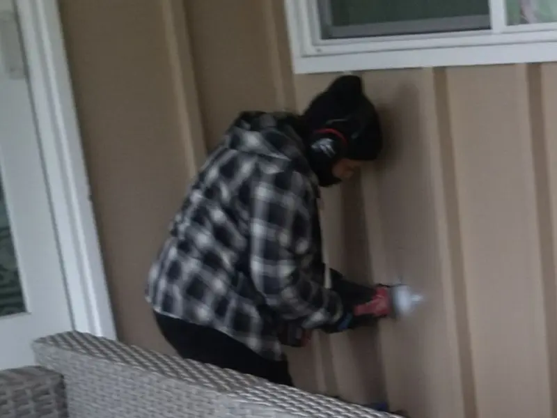Professional electrician installing an exterior outlet in Wallace
